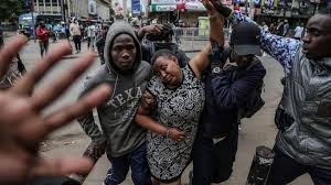 • Businesses have been shut in central Nairobi where this woman was helped after tear gas was fired by police