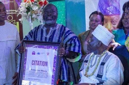 Prof. Wosornu receiving a citation at the launch