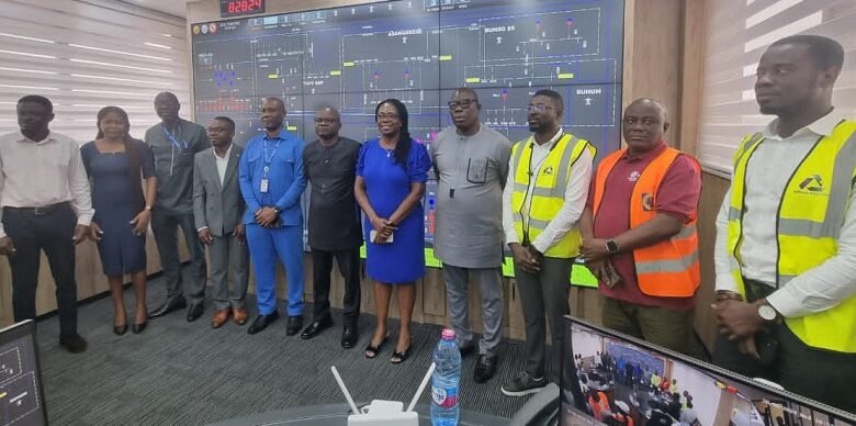 • Mr Solomon Adjetey (middle) and Mrs Sariel Adobea Etwire with staff and management of ECG