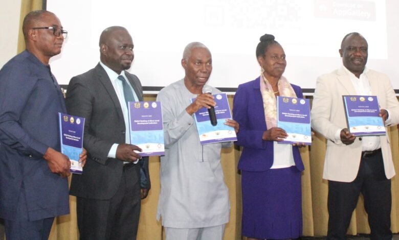 Prof. Kofi Awusabo-Asare (middle), Prof. Samuel K. Annim (second from left), Dr Grace Bediako (second from right) and other dignitaries launching the report Photo: Ebo Gorma