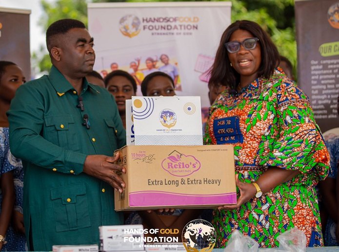 • Mr Larry George Botchwey presenting some of the package to Mrs Rejoice Acolor