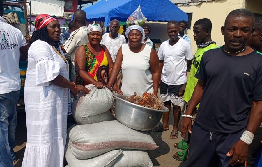 • Ms Sowah (left) presenting the food items to one of the representatives of the clan houses
