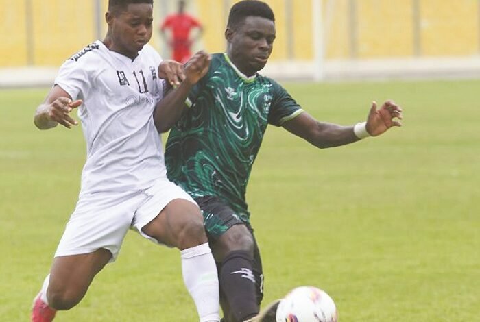 • Isaac Afful (right), the lone goal scorer, in a fierce tussle for the ball with Enow Enow of Victoria United Photo: Raymond Ackumey