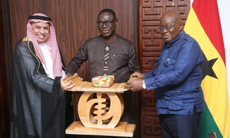 • President Akufo-Addo presenting a gift to Mr Abduolaye Al-Khalid (left)