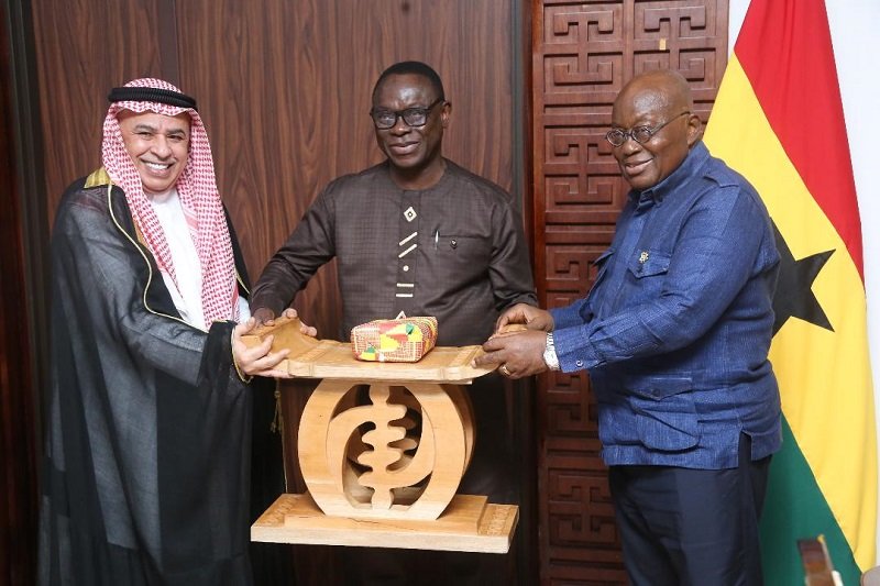 • President Akufo-Addo presenting a gift to Mr Abduolaye Al-Khalid (left)