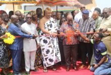 • President Akufo-Addo (middle) being assisted by King Tackie Tawiah Tsuri II, Ga Mantse (fifth from left), and some ministers of state to inaugurate the heavy duty trucks for the DRIP project