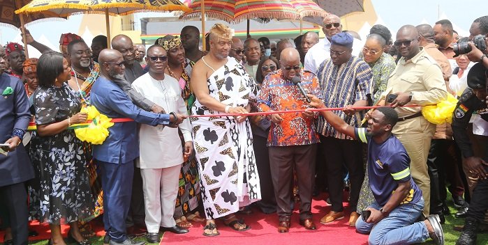 • President Akufo-Addo (middle) being assisted by King Tackie Tawiah Tsuri II, Ga Mantse (fifth from left), and some ministers of state to inaugurate the heavy duty trucks for the DRIP project