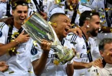 • Mbappe (with trophy in hand) celebrating with his team mates