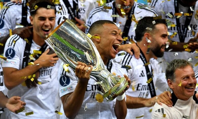 • Mbappe (with trophy in hand) celebrating with his team mates