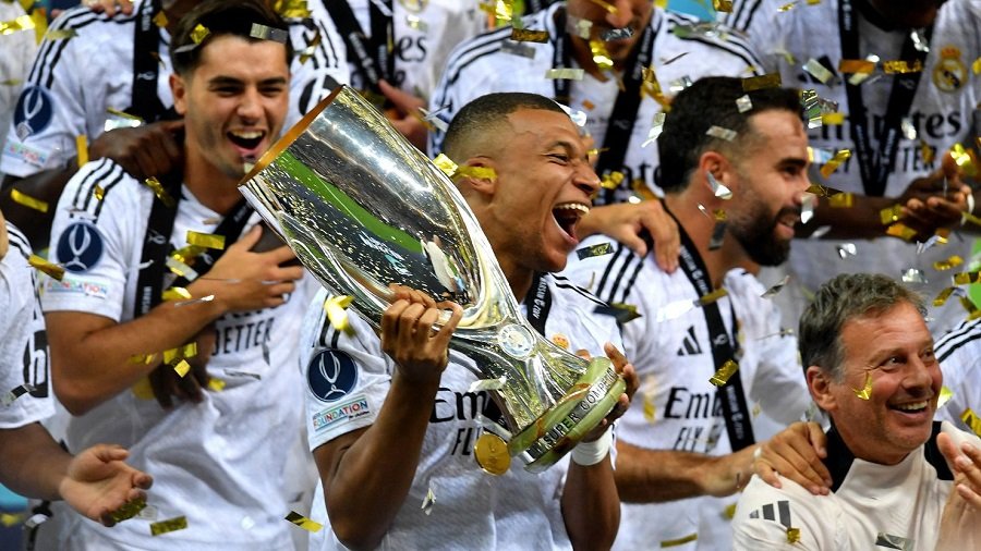 • Mbappe (with trophy in hand) celebrating with his team mates