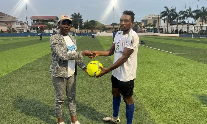 Match commissioner Abigail Sowah presenting the match ball to Kwasi Ankomah