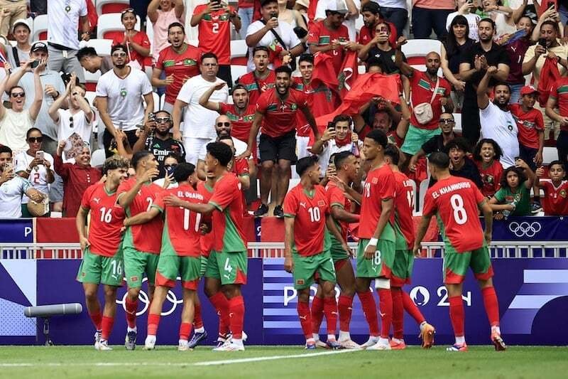 • Morocco players and fans celebrating their victory