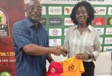 • Mr Walker presenting a polo shirt to Madam Dougbor