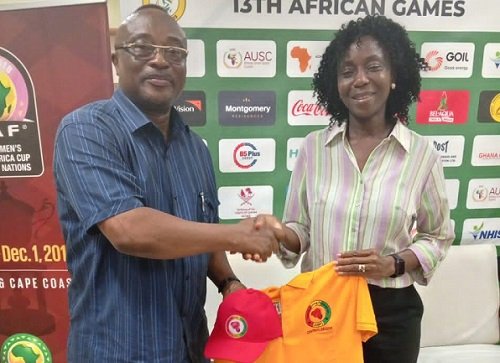 • Mr Walker presenting a polo shirt to Madam Dougbor