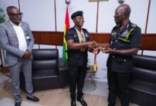 • Ms Minta presenting the medals to Dr Dampare (right). Looking on is Mr Osei Asibey