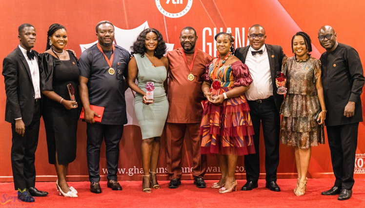 • Staff of Serene Insurance pose with the awards