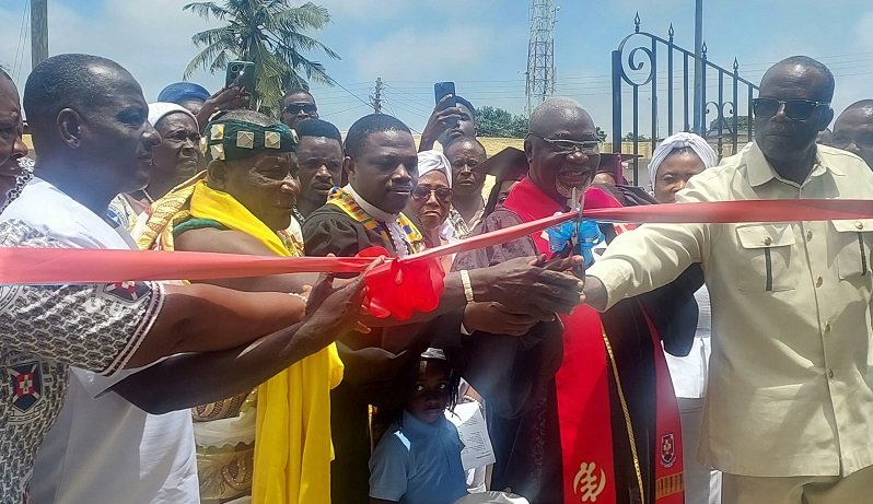 • Rev. Enoch Adjei Pobee (second from right) being assisted by other dignitaries to cut the tape for work to begin