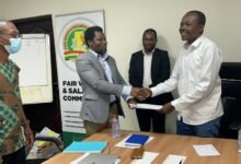 Ben Arthur (right) Chief Executive Officer (CEO) of the Fair Wages and Salaries Commission and Peter Akudugi Ayamba, (left) President of Ghana  Physician Assistants Association (GPAA) exchanging documents after signing the agreement