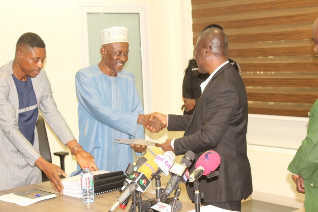 Mr Samuel Tetteh (right) Deputy Commissioner in charge of Operations, EC receiving NDP presidential candidate forms from Alhaji Mohammed Frimpong, the Flagbearer