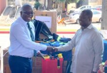 • Dr Bryan Acheampong (left) exchanging pleasantries with Mr Kofi Baah Agyepong, Chief Executive Officer of the YEA, after handing over the starter packs