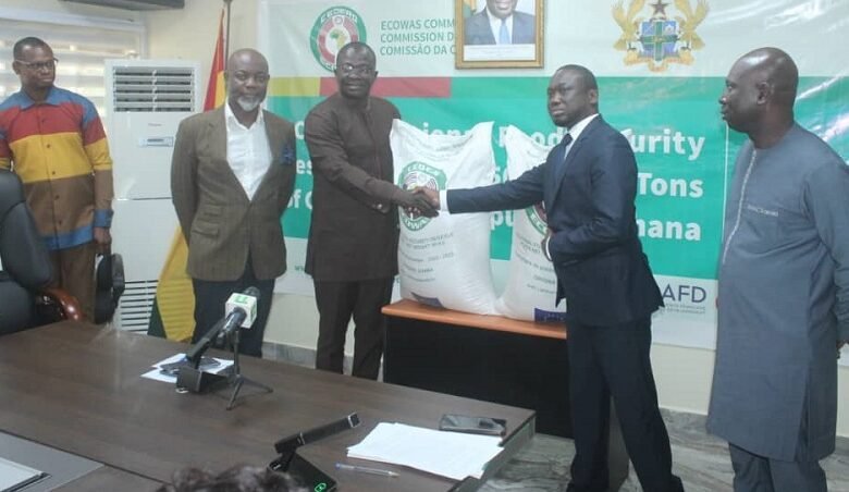 • Mr Ndiane Charles (second from right) handing over the cereals to Dr Acheampong. With them are other dignitaries