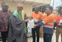 Mr. Feng Baoli (right), making a presentation of the medical consumables, Dialysis machine to the the Paramount Chief of the Talensi Traditional Area, Naba Kubilsong Namalteng (left)