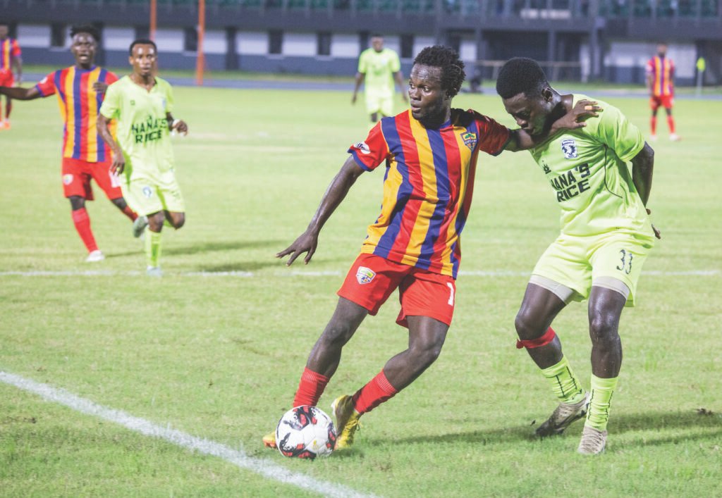 Mohammed Hussein is challenged for the ball by David Asenso Asabere in this scene PHOTO: RAYMOND ACKUMEY