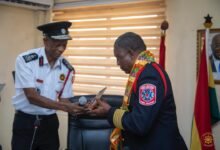 Mr Julius Kuunour (left)presenting a plaque to Col Barvoul Warsuwah