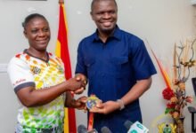 Mr Mustapha Ussif (right) receiving the medal from Grace Mintah