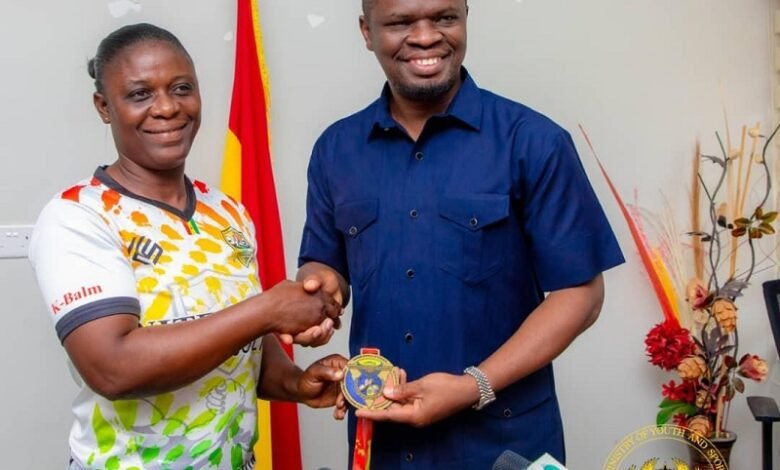 Mr Mustapha Ussif (right) receiving the medal from Grace Mintah