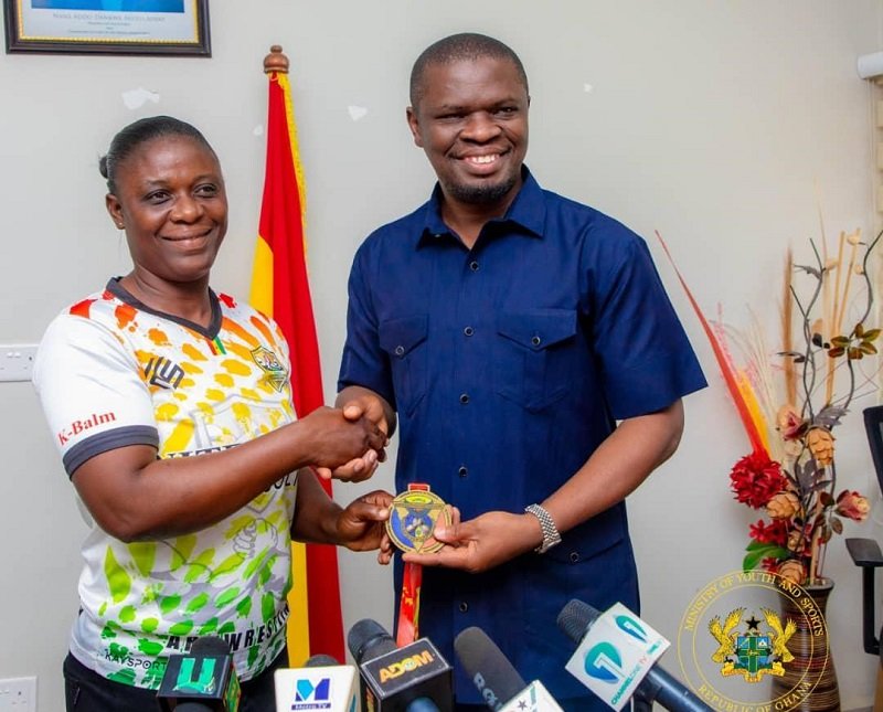 Mr Mustapha Ussif (right) receiving the medal from Grace Mintah