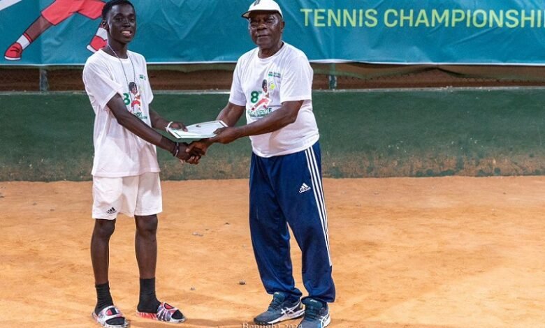 • Mr Peter Annan presenting a certificate to the boys U-14 winner Jeff Frimpong