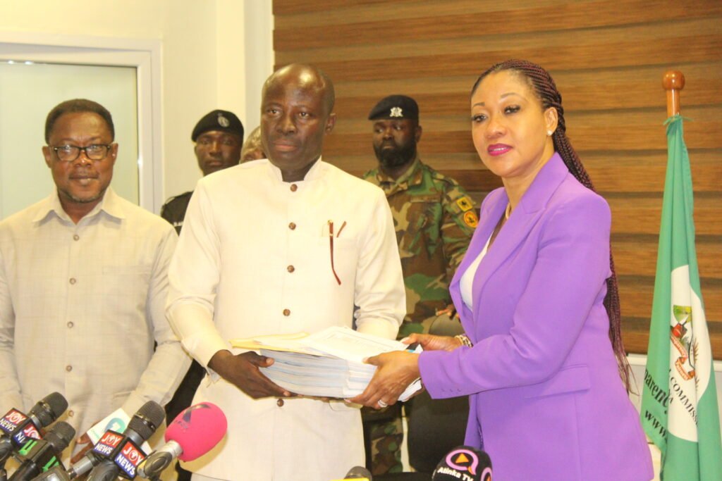 Mrs Jean Mensa, (right) receiving the documents of Mr Christian Kwabena Andrews, Flagbearer, Ghana Union Movement from Mr Anthony Gold Ahinful,General-Secretary,GUM