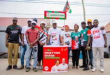 • Shafik Mahama (middle) and some NDC supporters behind the desk