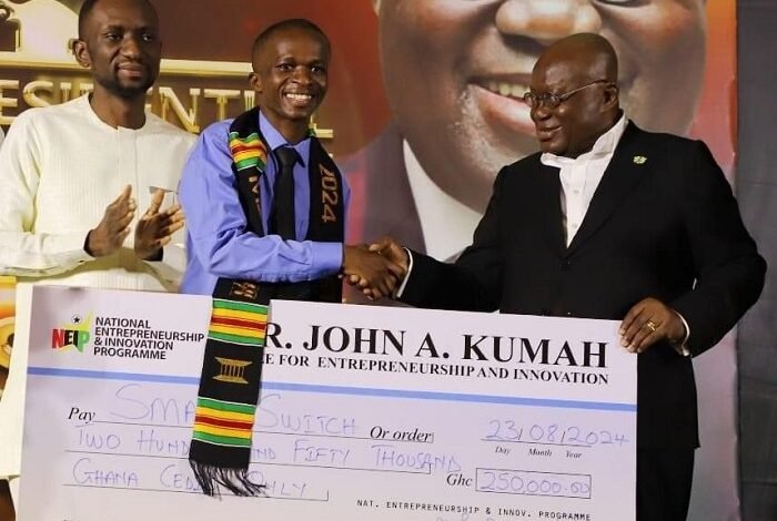 • President Akufo-Addo (right) presenting the cheque to Mr Naamgwinaa (middle)