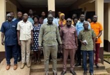 • Mr Daniel Machator (middle) with staff of Nkwanta - South Municipal Assembly