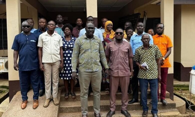 • Mr Daniel Machator (middle) with staff of Nkwanta - South Municipal Assembly