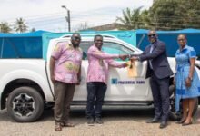 • Mr Bernard Gyebi (in suit) presenting the keys to Mr Lawrence Sarpong