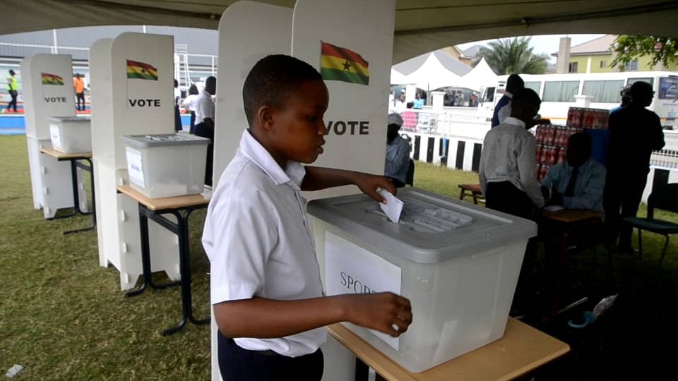 • A student casting his ballot