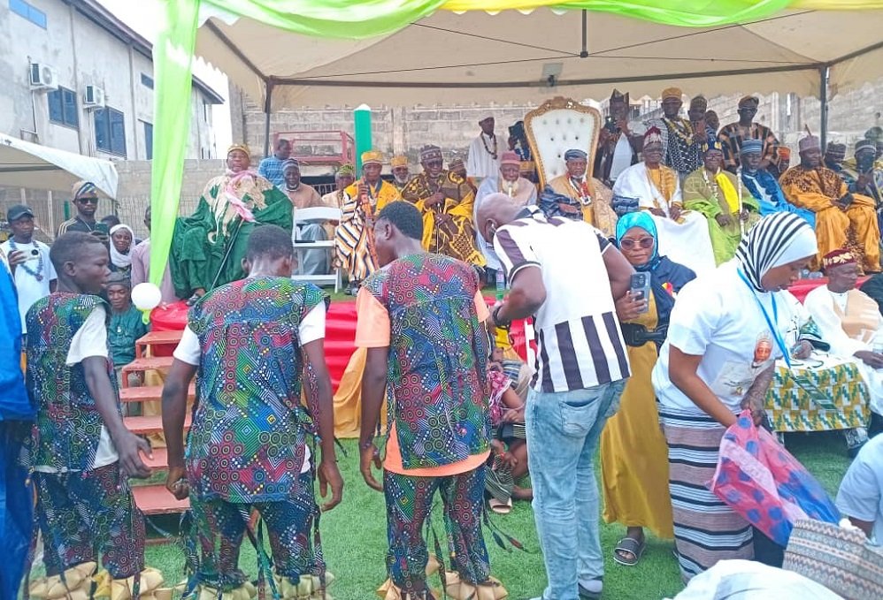 • A cultural troupe entertaining the gathering. Seated on the dais in the white chair is Chief Dabre IV