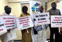 • Mrs Narteh (second from left) with some members of the CSOs platform holding placards at the conference Photo: Cynthia Asampana