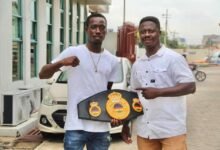 • Coach Carl Lokko (right) and John Laryea with his title