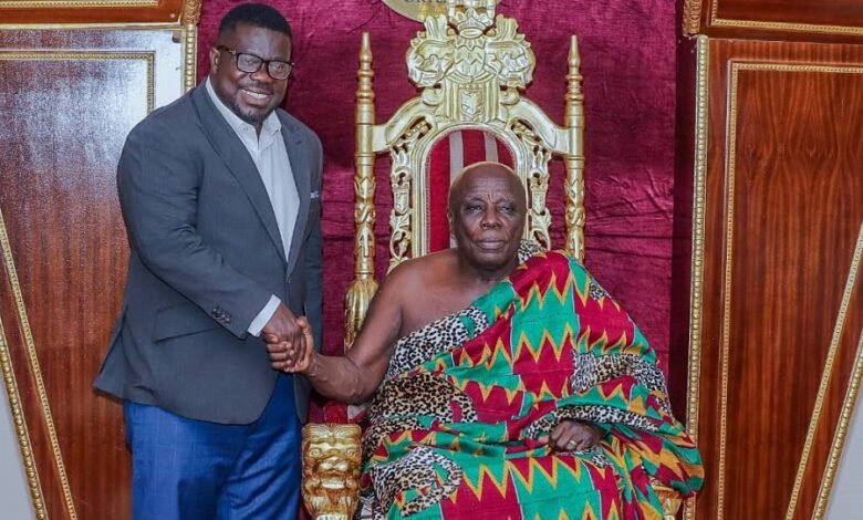 • The Okyenhene (seated) in a handshake with Mr Kuffour