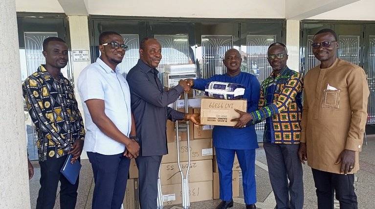 • Rev. Dr Bentil (third from left) presenting the items to Mr Afenyo (third from right)