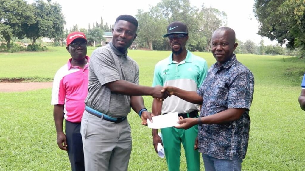 • Lucky Ayisah (left) receiving the winner's cheque from Prof Benard Kofi Baiden (right