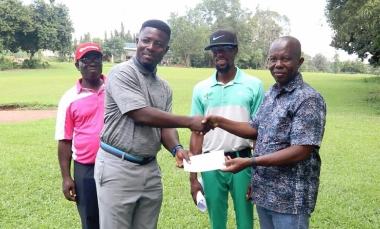 • Lucky Ayisah (left) receiving the winner's cheque from Prof Benard Kofi Baiden (right