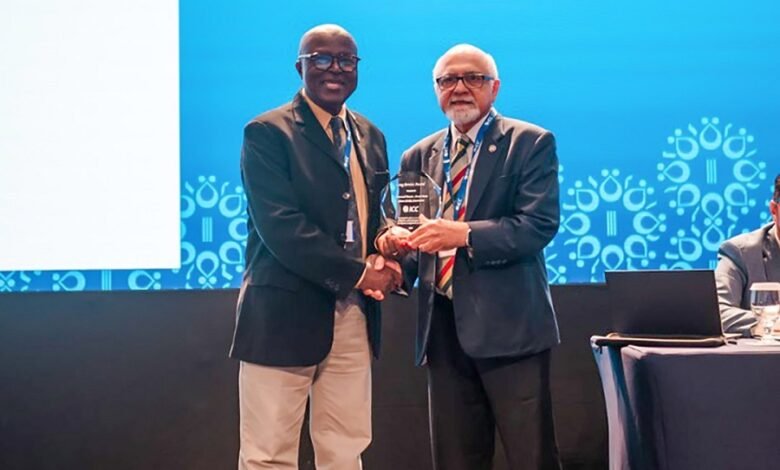 • Mr Asare (left) receiving his trophy from the ICC officials