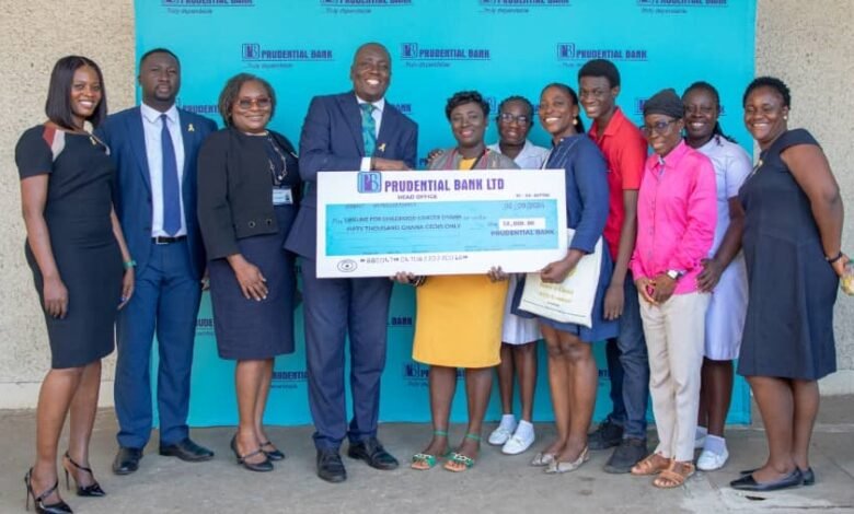 • Mr Quayson (fourth from left) presenting the cheque's to Ms Sarpong