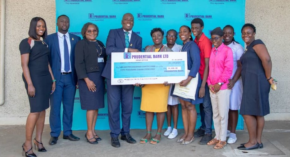 • Mr Quayson (fourth from left) presenting the cheque's to Ms Sarpong