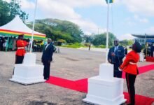 Mr Kwaku Ampratwum-Sarpong (second from right) hoisting the Ghana flag. Photo Stephanie Birikorang